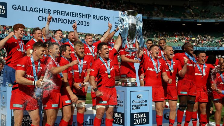 Saracens rugby team celebrating 2019 Gallagher Premiership Rugby championship with trophy and champagne spray