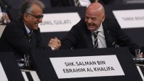 Gianni Infantino shaking hands with Sheikh Salman bin Ebrahim Al Khalifa at a formal event, both smiling.