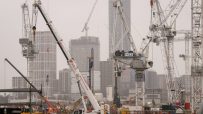 HS2 construction site with multiple cranes, buildings under development, and Select plant hire equipment on a cloudy day
