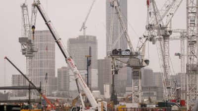 HS2 construction site with multiple cranes, buildings under development, and Select plant hire equipment on a cloudy day