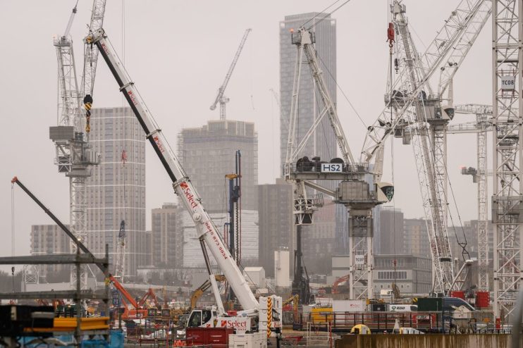 HS2 construction site with multiple cranes, buildings under development, and Select plant hire equipment on a cloudy day