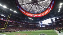 Interior view of Mercedes-Benz Stadium with the Atlanta Falcons logo and text on the upper ring display.