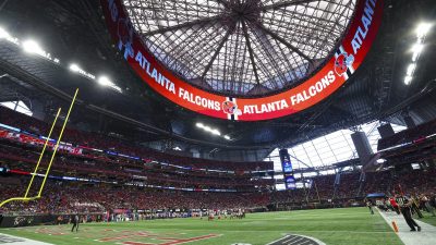 Interior view of Mercedes-Benz Stadium with the Atlanta Falcons logo and text on the upper ring display.