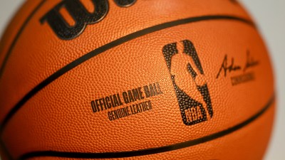 Close-up of an official NBA game ball, revealing its textured leather surface and OFFICIAL GAME BALL inscription