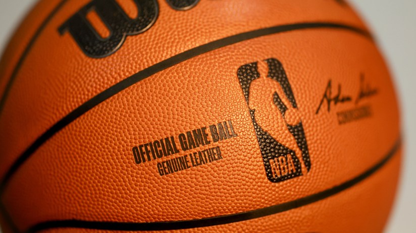 Close-up of an official NBA game ball, revealing its textured leather surface and OFFICIAL GAME BALL inscription