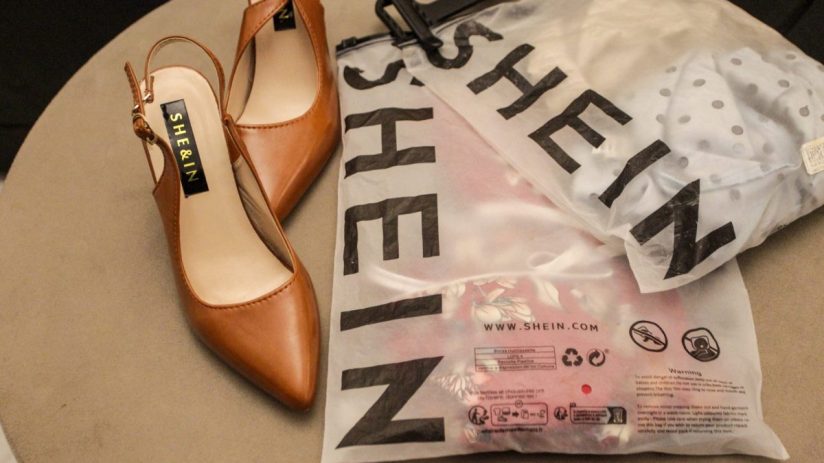 Brown slingback heels next to Shein branded plastic packaging with clothing inside.