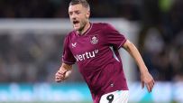 Jamie Vardy in a burgundy Leicester City football kit with Vertu sponsor, number 9, on a pitch