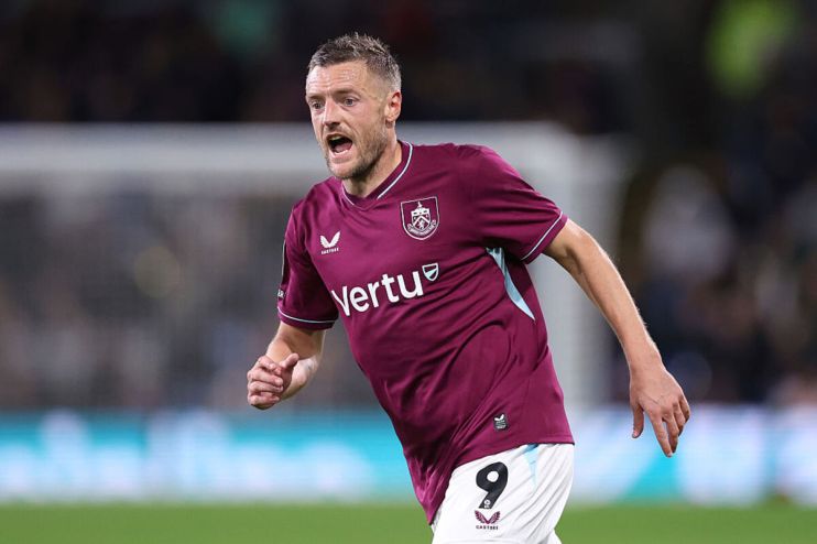 Jamie Vardy in a burgundy Leicester City football kit with Vertu sponsor, number 9, on a pitch