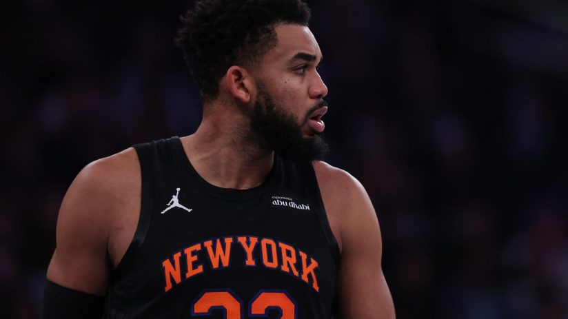 Basketball player in a New York Knicks jersey with 32 and NEW YORK visible, looking right.