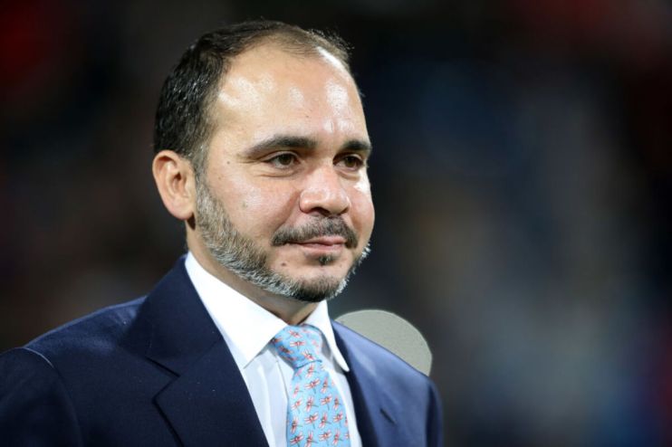Prince Ali bin Hussein of Jordan, wearing a blue suit and patterned tie, looking right.