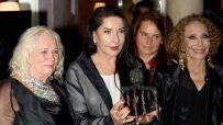 Marina Abramović holding a bronze award, flanked by three women at a Liberatum event