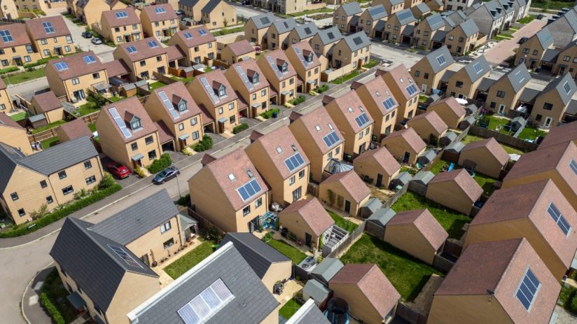 Aerial view of a new build housing estate with many homes featuring solar panels