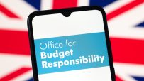 Smartphone displaying Office for Budget Responsibility logo against a blurred Union Jack flag.