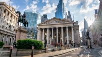 The Royal Exchange and Bank of England building in Londons financial district, with modern skyscrapers behind.