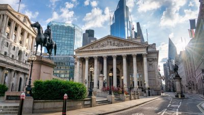 The Royal Exchange and Bank of England building in Londons financial district, with modern skyscrapers behind.