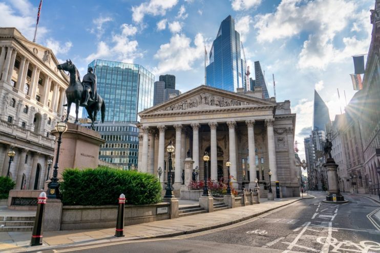 The Royal Exchange and Bank of England building in Londons financial district, with modern skyscrapers behind.