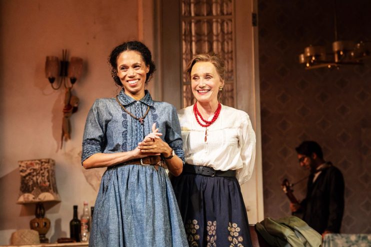 Smiling actresses from The Cherry Orchard at Harold Pinter Theatre, one in denim, one in white blouse and red beads.