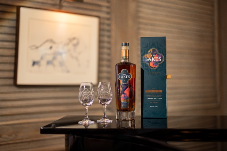 The Lakes Chocolatier limited edition whisky bottle, two branded glasses, and gift box on a dark surface