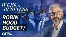 Christian May with two men in suits and Robin Hood hats, bow and arrows, for Week in Business: Robin Hood Budget?