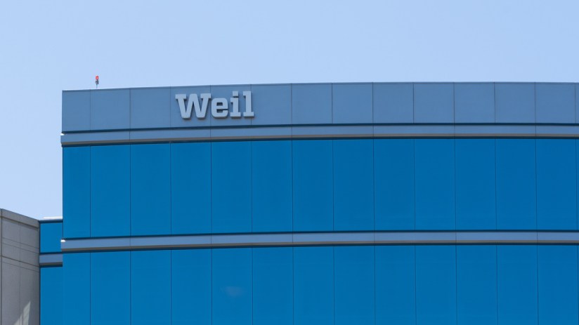 Weil Gotshal & Manges law firm building with blue reflective windows and the Weil logo on top.