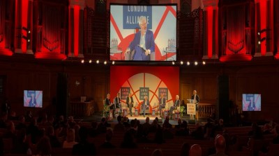 Panel discussion at the Central London Alliance Summit 2025 with speakers on stage and a large screen displaying the event...