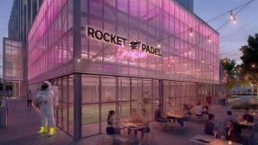Rocket Padel Croydon exterior at dusk with pink lighting, outdoor dining, and an astronaut statue.