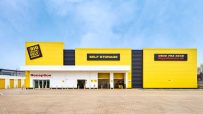 Big Yellow Self Storage facility exterior with yellow facade, reception entrance, and SELF STORAGE sign under a blue sky