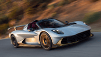Silver sports car with gold accents speeding on a road, motion blur in background