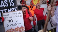 Protesters demonstrating against the controversial Jackdaw gas field, holding signs saying NO to Jackdaw and Oil Gas.