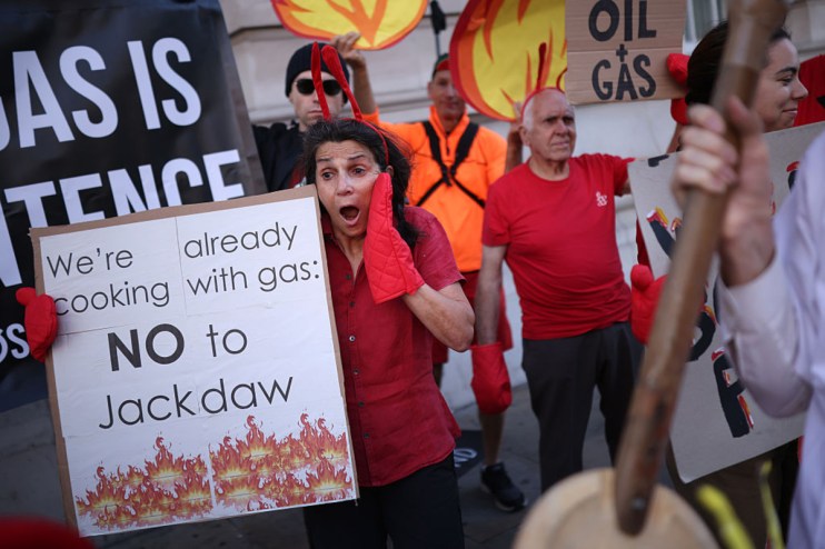 Protesters demonstrating against the controversial Jackdaw gas field, holding signs saying NO to Jackdaw and Oil Gas.
