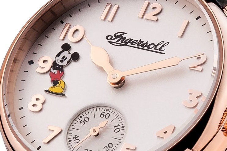 Close-up of a rose gold Ingersoll Mickey Mouse watch face with white dial and small seconds sub-dial.