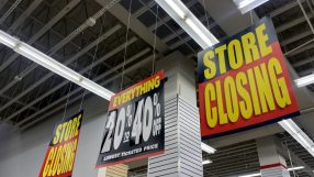Store Closing signs and a 20% to 40% Off sale sign hanging inside a retail store.