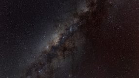 Milky Way galaxy spanning across a dark night sky, filled with countless stars, dust, and nebulae.