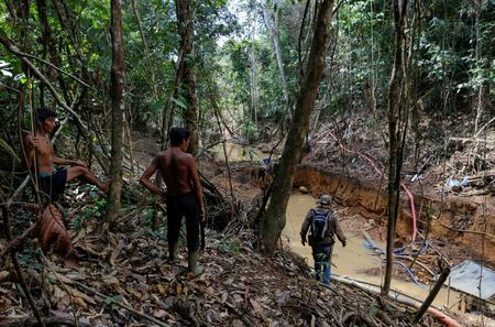 Yanomami Indians follow agents of Brazil's environmental agency in the heart of the Amazon rainforest. 
