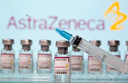  Vials labelled "AstraZeneca COVID-19 Coronavirus Vaccine" and a syringe are seen in front of a displayed AstraZeneca logo in this illustration taken March 10, 2021. REUTERS/Dado Ruvic/Illustration/File Photo