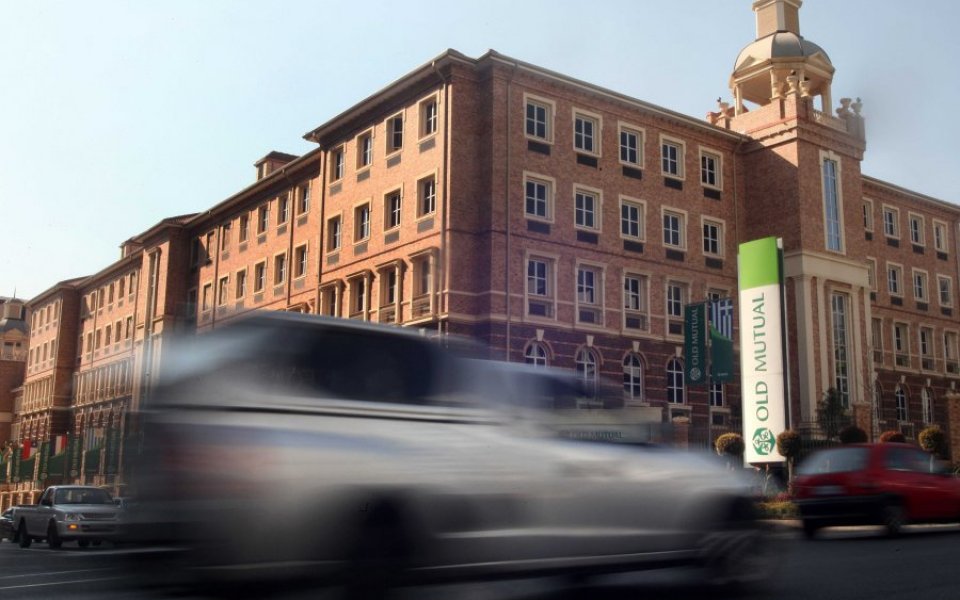 Cars drive past an Old Mutual building in South Africa.