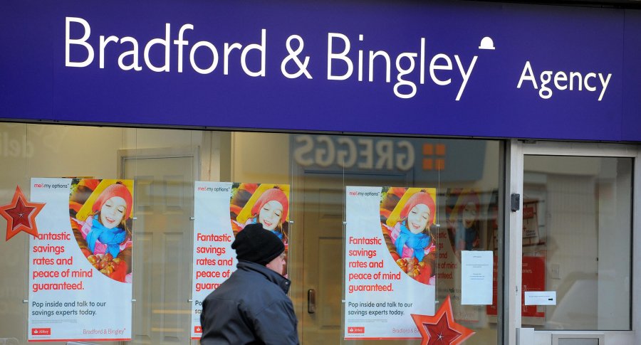 A man walks past adverts offering saving